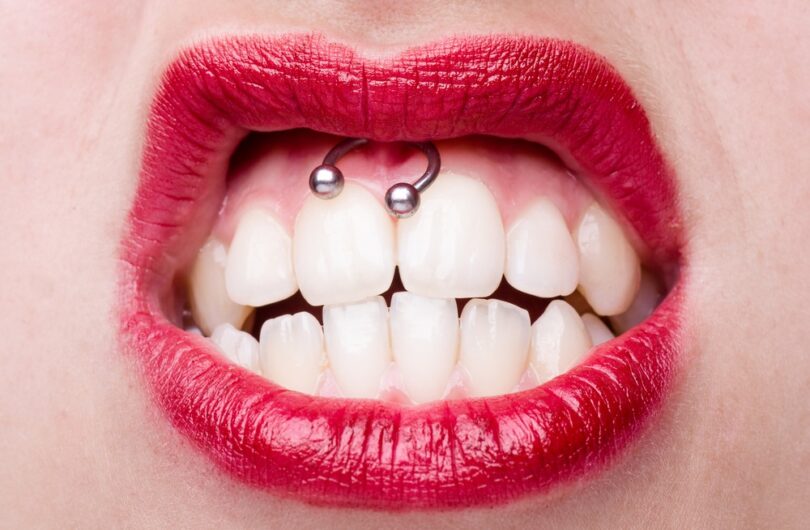 Smiley,Piercing,Detail,With,Snarling,Woman's,Mouth